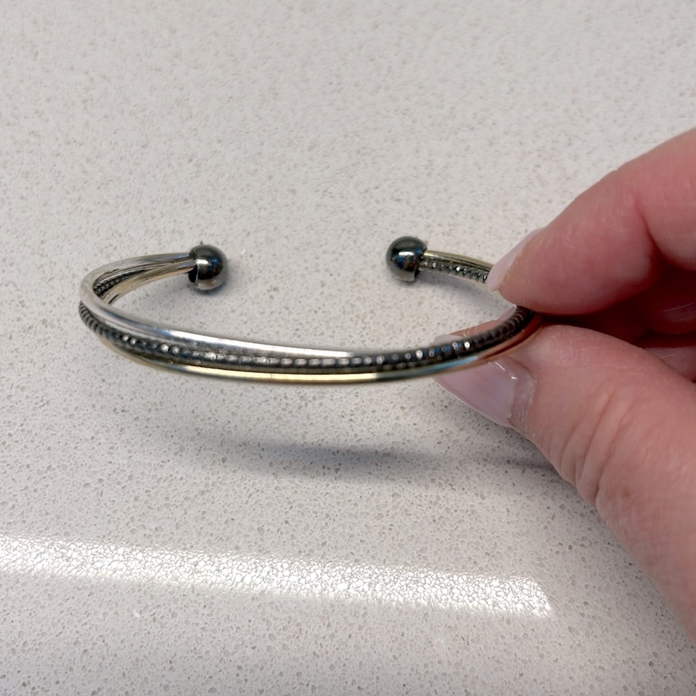 Charming Charlie tri-tone bangle in silver, gold & black